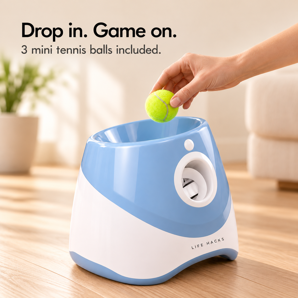 Loading a 2-inch mini tennis ball into the top of the blue dog ball launcher